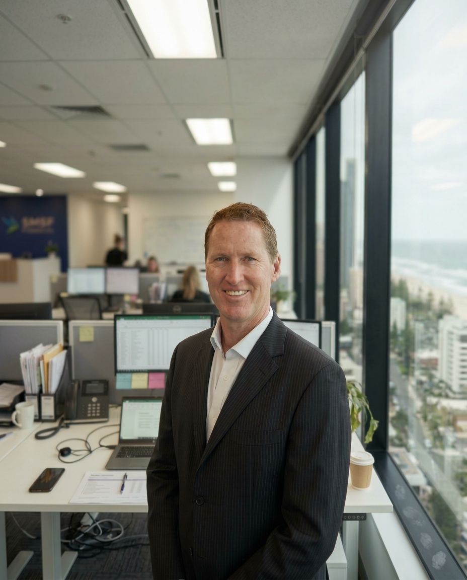 Jason Bibby, founder of SMSF Financial, in the Level 5 Cavill Avenue office with Surfers Paradise behind